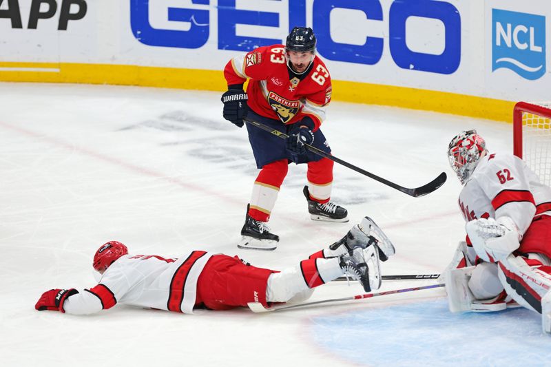 May 24, 2025; Sunrise, Florida, USA; Carolina Hurricanes defenseman Jaccob Slavin (74) blocks the shot from Florida Panthers center Brad Marchand (63) during the second period in game three of the Eastern Conference Final of the 2025 Stanley Cup Playoffs at Amerant Bank Arena. Mandatory Credit: Sam Navarro-Imagn Images