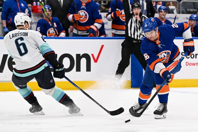 Feb 13, 2024; Elmont, New York, USA; New York Islanders right wing Oliver Wahlstrom (26) makes a move around Seattle Kraken defenseman Adam Larsson (6) during the second period at UBS Arena. Mandatory Credit: Dennis Schneidler-USA TODAY Sports