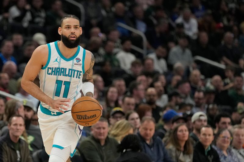 MILWAUKEE, WISCONSIN - FEBRUARY 27: Cody Martin #11 of the Charlotte Hornets dribbles the ball during the first half against the Milwaukee Bucks at Fiserv Forum on February 27, 2024 in Milwaukee, Wisconsin. NOTE TO USER: User expressly acknowledges and agrees that, by downloading and or using this photograph, User is consenting to the terms and conditions of the Getty Images License Agreement. (Photo by Patrick McDermott/Getty Images)