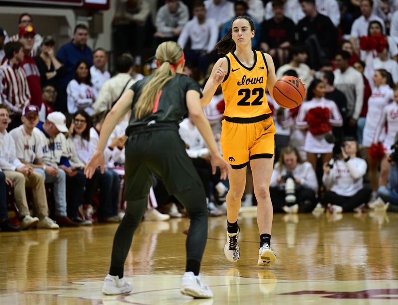 Feb 22, 2024; Bloomington, Indiana, USA; Iowa Hawkeyes guard Caitlin Clark (22) dribbles the ball during the first period against the Indiana Hoosiers at Simon Skjodt Assembly Hall. Mandatory Credit: Marc Lebryk-USA TODAY Sports