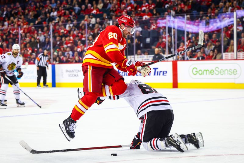 Oct 15, 2024; Calgary, Alberta, CAN; Calgary Flames center Blake Coleman (20) jumps over Chicago Blackhawks center Teuvo Teravainen (86) during the third period at Scotiabank Saddledome. Mandatory Credit: Sergei Belski-Imagn Images