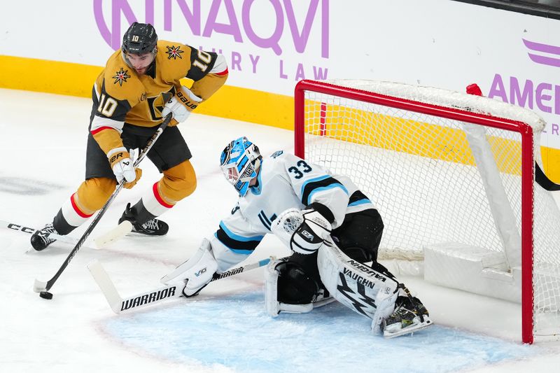 Nov 30, 2024; Las Vegas, Nevada, USA; Vegas Golden Knights center Nicolas Roy (10) controls the puck in front of Utah Hockey Club goaltender Jaxson Stauber (33) during the first period at T-Mobile Arena. Mandatory Credit: Stephen R. Sylvanie-Imagn Images