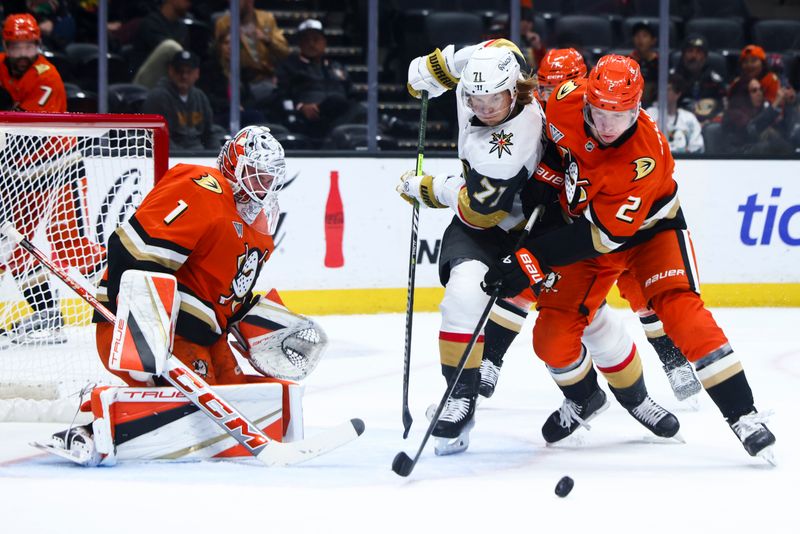 Nov 13, 2024; Anaheim, California, USA; Vegas Golden Knights center William Karlsson (71) battles for the puck against Anaheim Ducks defenseman Jackson LaCombe (2) during the first period of a hockey game at Honda Center. Mandatory Credit: Jessica Alcheh-Imagn Images