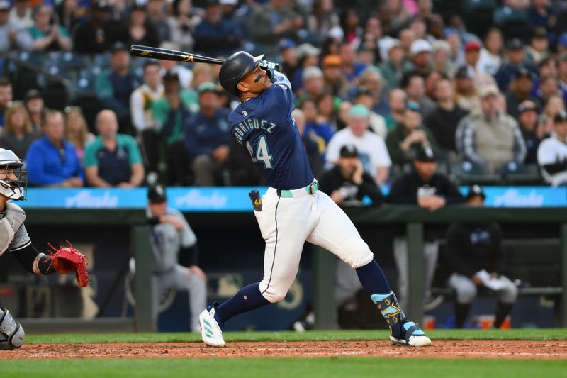 Jun 13, 2024; Seattle, Washington, USA; Seattle Mariners center fielder Julio Rodriguez (44) hits a home run against the Chicago White Sox during the ninth inning at T-Mobile Park. Mandatory Credit: Steven Bisig-USA TODAY Sports