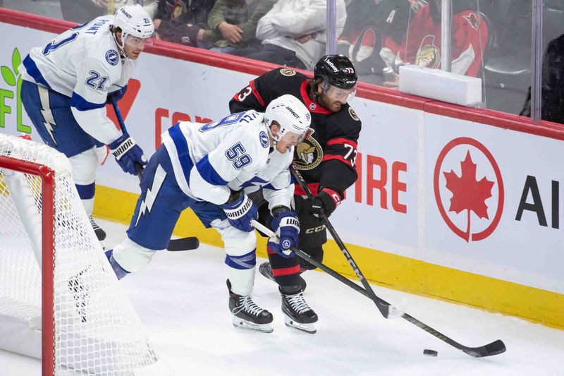 Oct 19, 2024; Ottawa, Ontario, CAN; Tampa Bay Lightning center Jake Guentzel (59) and Ottawa Senators left wing Noah Gregor (73) battle for control of the puck in the third period at the Canadian Tire Centre. Mandatory Credit: Marc DesRosiers-Imagn Images