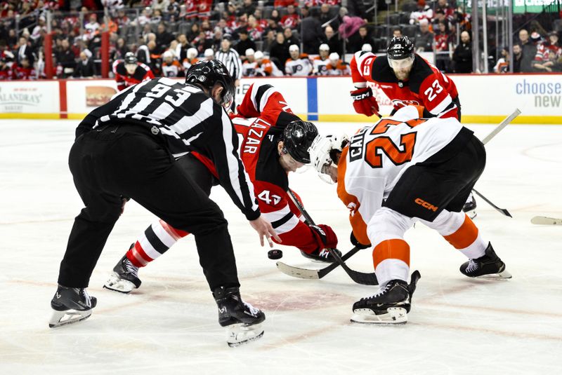 Jan 29, 2025; Newark, New Jersey, USA; New Jersey Devils defenseman Luke Hughes (43) faces off against Philadelphia Flyers left wing Noah Cates (27) during the third period at Prudential Center. Mandatory Credit: John Jones-Imagn Images
