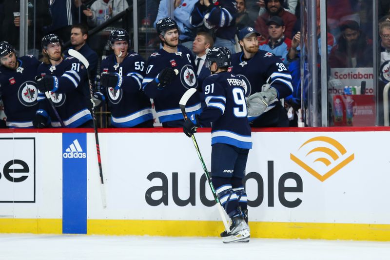 Nov 11, 2023; Winnipeg, Manitoba, CAN;  Winnipeg Jets forward Cole Perfetti (91) is congratulated by his teammates on his goal against the Dallas Stars during the second period at Canada Life Centre. Mandatory Credit: Terrence Lee-USA TODAY Sports