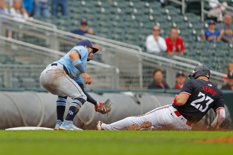 Jun 20, 2024; Minneapolis, Minnesota, USA; Tampa Bay Rays third baseman Isaac Paredes (17) tags out Minnesota Twins third baseman Royce Lewis (23) who tried to advance on a sacrifice fly attempt in the tenth inning at Target Field. Mandatory Credit: Bruce Kluckhohn-USA TODAY Sports