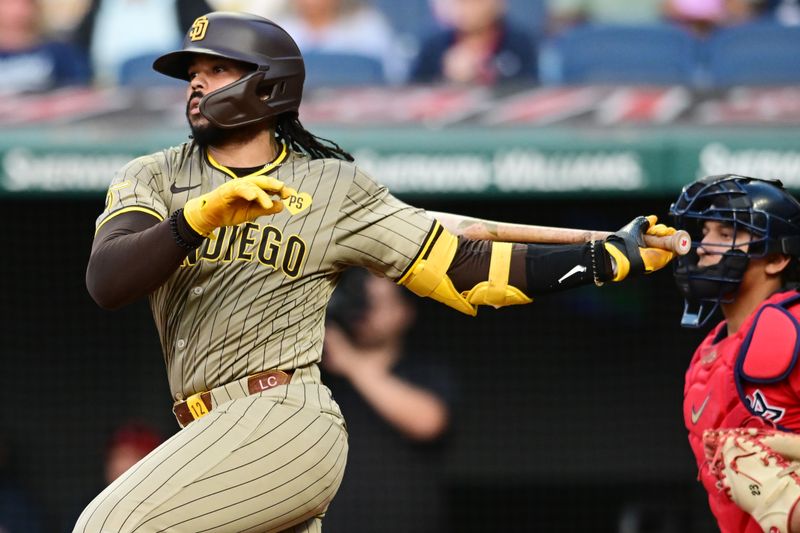 Jul 20, 2024; Cleveland, Ohio, USA; San Diego Padres catcher Luis Campusano (12) hits an RBI single during the fourth inning against the Cleveland Guardians at Progressive Field. Mandatory Credit: Ken Blaze-USA TODAY Sports