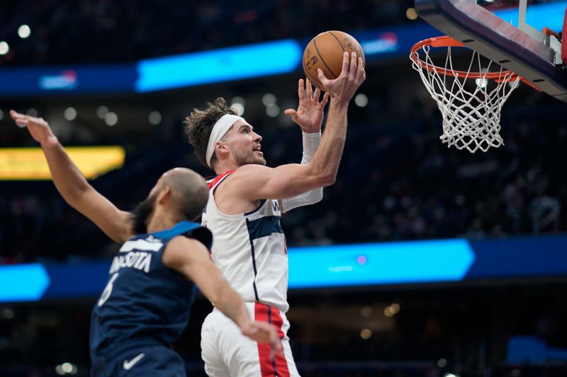 WASHINGTON, DC - JANUARY 24: Corey Kispert #24 of the Washington Wizards shoots against Jordan McLaughlin #6 of the Minnesota Timberwolves during the second half at Capital One Arena on January 24, 2024 in Washington, DC. NOTE TO USER: User expressly acknowledges and agrees that, by downloading and or using this photograph, User is consenting to the terms and conditions of the Getty Images License Agreement. (Photo by Jess Rapfogel/Getty Images)