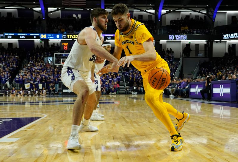 Feb 2, 2023; Evanston, Illinois, USA; Northwestern Wildcats center Matthew Nicholson (34) defends Michigan Wolverines center Hunter Dickinson (1) during the first half at Welsh-Ryan Arena. Mandatory Credit: David Banks-USA TODAY Sports