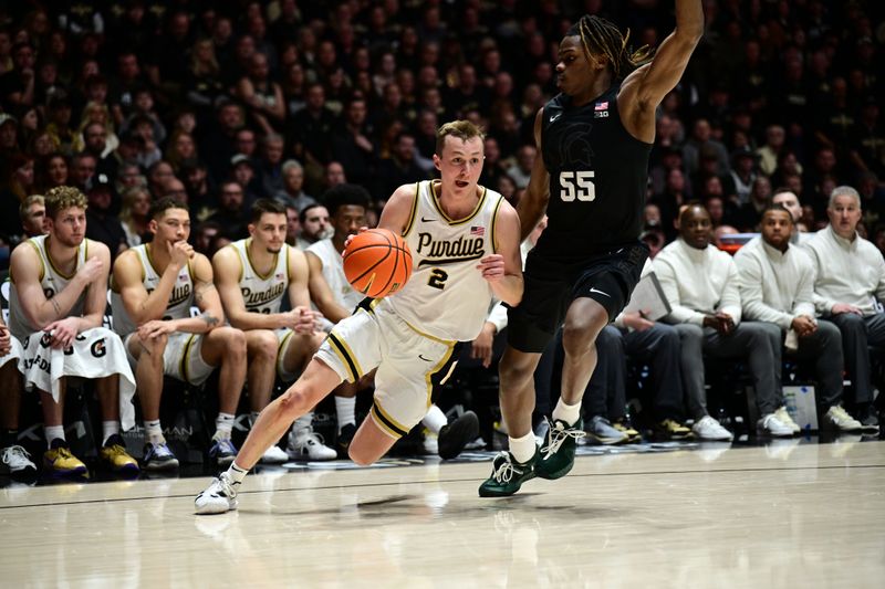 Mar 2, 2024; West Lafayette, Indiana, USA; Purdue Boilermakers guard Fletcher Loyer (2) drives the ball around Michigan State Spartans forward Coen Carr (55) during the second half of the game at Mackey Arena. Mandatory Credit: Marc Lebryk-USA TODAY Sports