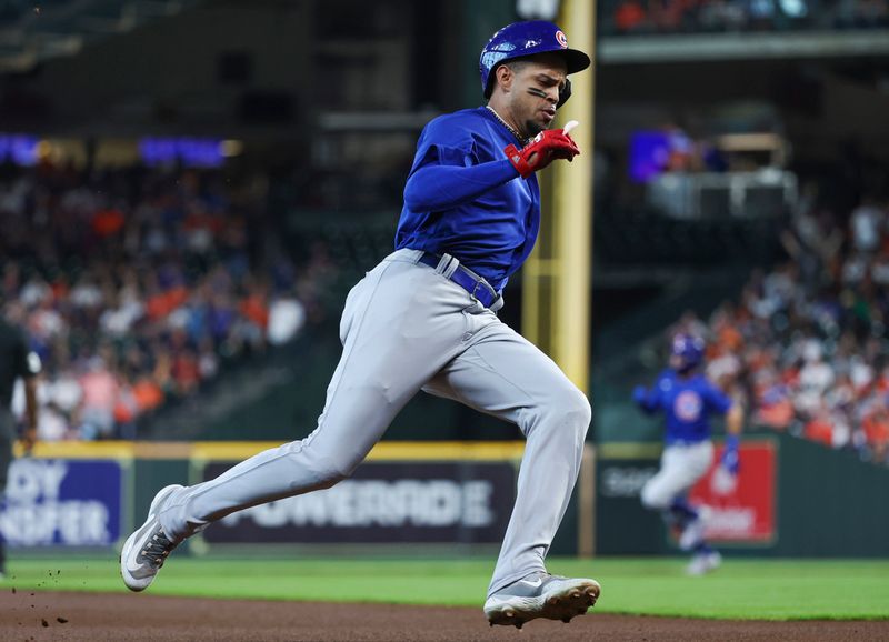 May 17, 2023; Houston, Texas, USA; Chicago Cubs center fielder Christopher Morel (5) rounds third base and scores a run on a triple by shortstop Dansby Swanson (7) during the first inning against the Houston Astros at Minute Maid Park. Mandatory Credit: Troy Taormina-USA TODAY Sports
