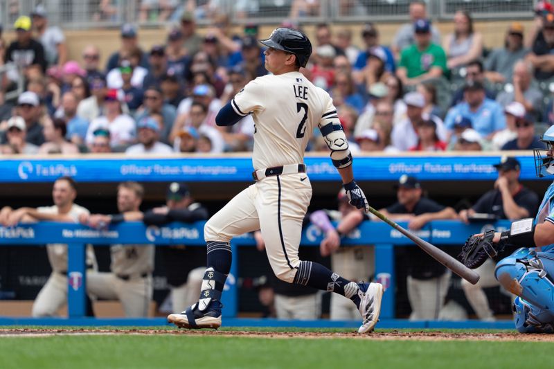 Jun 8, 2025; Minneapolis, Minnesota, USA; Minnesota Twins third baseman Brooks Lee (2) hits a single during the second inning against the Toronto Blue Jays at Target Field. Mandatory Credit: Jordan Johnson-Imagn Images