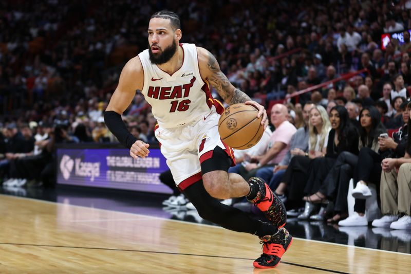 MIAMI, FLORIDA - JANUARY 31: Caleb Martin #16 of the Miami Heat dribbles the ball against the Sacramento Kings during the fourth quarter of the game at Kaseya Center on January 31, 2024 in Miami, Florida. NOTE TO USER: User expressly acknowledges and agrees that, by downloading and or using this photograph, User is consenting to the terms and conditions of the Getty Images License Agreement. (Photo by Megan Briggs/Getty Images)