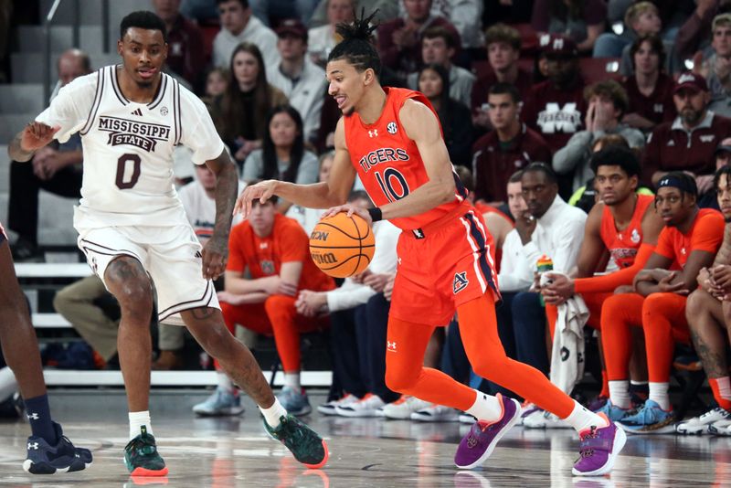 Jan 27, 2024; Starkville, Mississippi, USA; Auburn Tigers guard/forward Chad Baker-Mazara (10) dribbles as Mississippi State Bulldogs forward D.J. Jeffries (0) defends during the second half at Humphrey Coliseum. Mandatory Credit: Petre Thomas-USA TODAY Sports