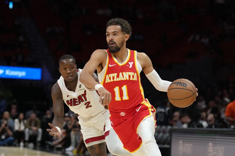 MIAMI, FL - OCTOBER 16: Trae Young #11 of the Atlanta Hawks dribbles the ball during the game against the Miami Heat during a preseason game on October 16, 2024 at Kaseya Center in Miami, Florida. NOTE TO USER: User expressly acknowledges and agrees that, by downloading and or using this Photograph, user is consenting to the terms and conditions of the Getty Images License Agreement. Mandatory Copyright Notice: Copyright 2024 NBAE (Photo by Eric Espada/NBAE via Getty Images)