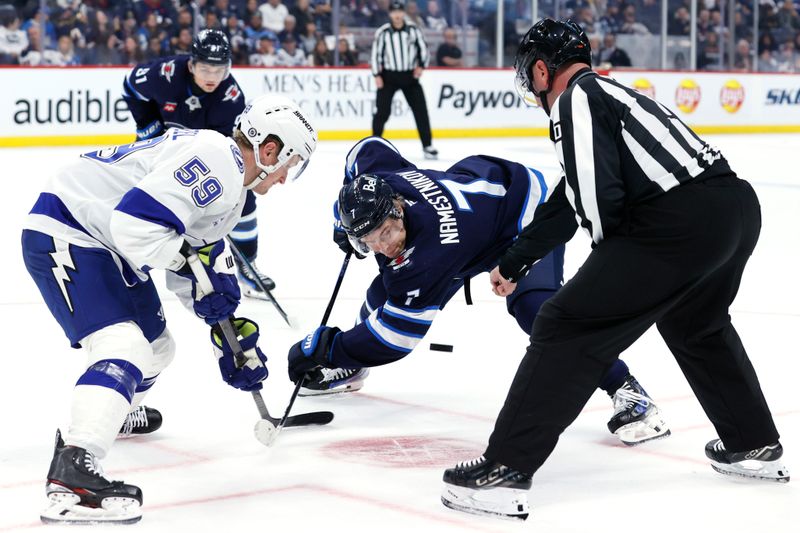 Nov 3, 2024; Winnipeg, Manitoba, CAN; Linesman Derek Nansen (70) drops the puck on a face-off with Tampa Bay Lightning center Jake Guentzel (59) and Winnipeg Jets center Vladislav Namestnikov (7) in the second period at Canada Life Centre. Mandatory Credit: James Carey Lauder-Imagn Images