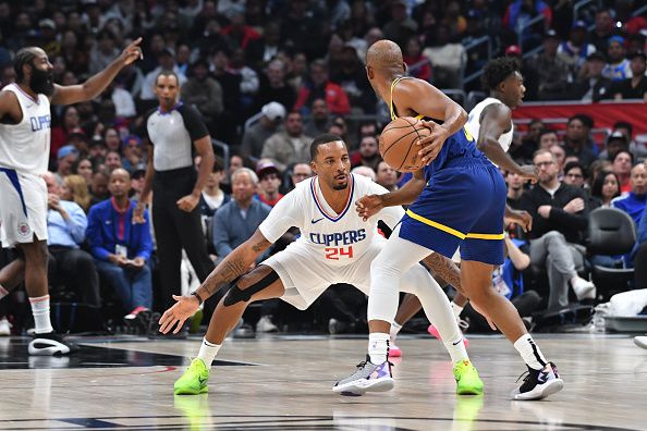 LOS ANGELES, CA - DECEMBER 14: Norman Powell #24 of the LA Clippers plays defense against Chris Paul #3 of the Golden State Warriors on December 14, 2023 at Crypto.Com Arena in Los Angeles, California. NOTE TO USER: User expressly acknowledges and agrees that, by downloading and/or using this Photograph, user is consenting to the terms and conditions of the Getty Images License Agreement. Mandatory Copyright Notice: Copyright 2023 NBAE (Photo by Juan Ocampo/NBAE via Getty Images)