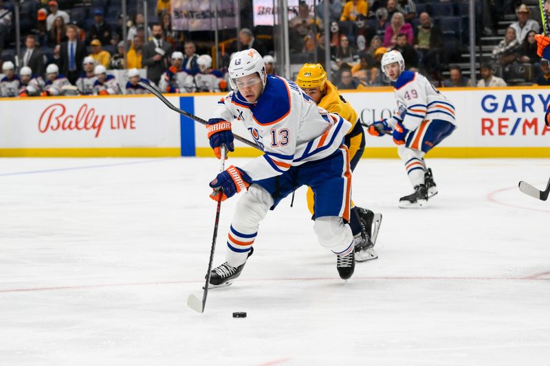 Oct 31, 2024; Nashville, Tennessee, USA;  Edmonton Oilers center Mattias Janmark (13) skates with the puck against the Nashville Predators during the third period at Bridgestone Arena. Mandatory Credit: Steve Roberts-Imagn Images