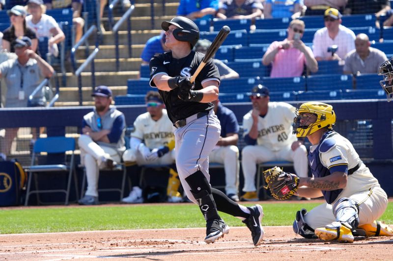 Mar 13, 2024; Phoenix, Arizona, USA; Chicago White Sox first baseman Andrew Vaughn (25) hits a single against the Milwaukee Brewers in the first inning at American Family Fields of Phoenix. Mandatory Credit: Rick Scuteri-USA TODAY Sports