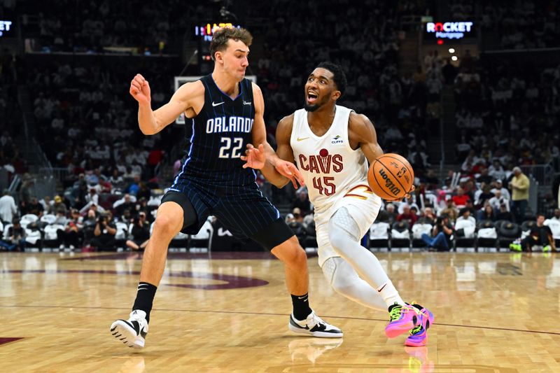 CLEVELAND, OHIO - APRIL 20: Franz Wagner #22 of the Orlando Magic guards Donovan Mitchell #45 of the Cleveland Cavaliers during the third quarter of game one of the Eastern Conference First Round Playoffs at Rocket Mortgage Fieldhouse on April 20, 2024 in Cleveland, Ohio. The Cavaliers defeated the Magic 97-83. NOTE TO USER: User expressly acknowledges and agrees that, by downloading and or using this photograph, User is consenting to the terms and conditions of the Getty Images License Agreement. (Photo by Jason Miller/Getty Images)