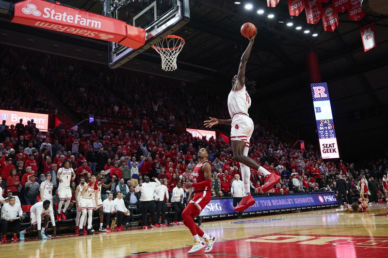 Jan 17, 2024; Piscataway, New Jersey, USA; Rutgers Scarlet Knights center Clifford Omoruyi (11) goes up for a dunk in front of Nebraska Cornhuskers guard Jamarques Lawrence (10) during the second half at Jersey Mike's Arena. Mandatory Credit: Vincent Carchietta-USA TODAY Sports