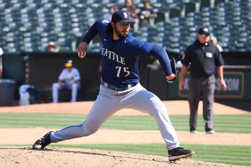Sep 20, 2023; Oakland, California, USA; Seattle Mariners relief pitcher Andres Munoz (75) pitches the ball against the Oakland Athletics during the eighth inning at Oakland-Alameda County Coliseum. Mandatory Credit: Kelley L Cox-USA TODAY Sports
