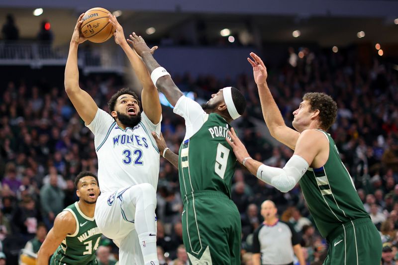 MILWAUKEE, WISCONSIN - FEBRUARY 08: Karl-Anthony Towns #32 of the Minnesota Timberwolves is defended by Bobby Portis #9 of the Milwaukee Bucks during a game at Fiserv Forum on February 08, 2024 in Milwaukee, Wisconsin. NOTE TO USER: User expressly acknowledges and agrees that, by downloading and or using this photograph, User is consenting to the terms and conditions of the Getty Images License Agreement. (Photo by Stacy Revere/Getty Images)