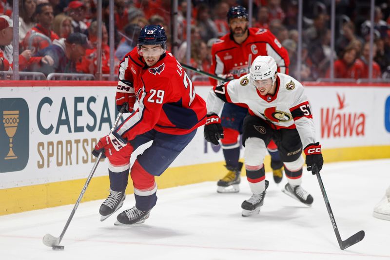 Feb 26, 2024; Washington, District of Columbia, USA; Washington Capitals center Hendrix Lapierre (29) skates with the puck as Ottawa Senators center Shane Pinto (57) chases in the second period at Capital One Arena. Mandatory Credit: Geoff Burke-USA TODAY Sports