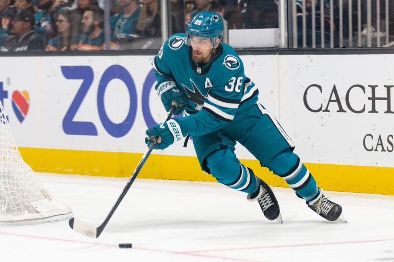 Dec 21, 2023; San Jose, California, USA; San Jose Sharks defenseman Mario Ferraro (38) controls the puck during the first period against the Arizona Coyotes at SAP Center at San Jose. Mandatory Credit: Stan Szeto-USA TODAY Sports