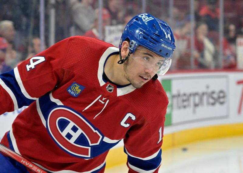 Apr 2, 2024; Montreal, Quebec, CAN; Montreal Canadiens forward Nick Suzuki (14) skates during the warmup period before the game against the Florida Panthers at the Bell Centre. Mandatory Credit: Eric Bolte-USA TODAY Sports