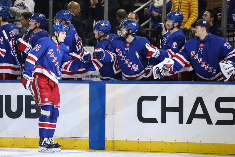 Nov 12, 2024; New York, New York, USA;  New York Rangers right wing Kaapo Kakko (24) celebrates with his teammates after scoring a goal in the third period against the Winnipeg Jets at Madison Square Garden. Mandatory Credit: Wendell Cruz-Imagn Images