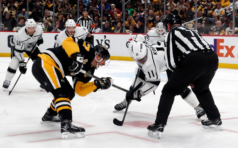 Feb 18, 2024; Pittsburgh, Pennsylvania, USA;  Pittsburgh Penguins center Sidney Crosby (87) takes a face-off against Los Angeles Kings center Anze Kopitar (11) during the third period at PPG Paints Arena.  Los Angeles won 2-1. Mandatory Credit: Charles LeClaire-USA TODAY Sports