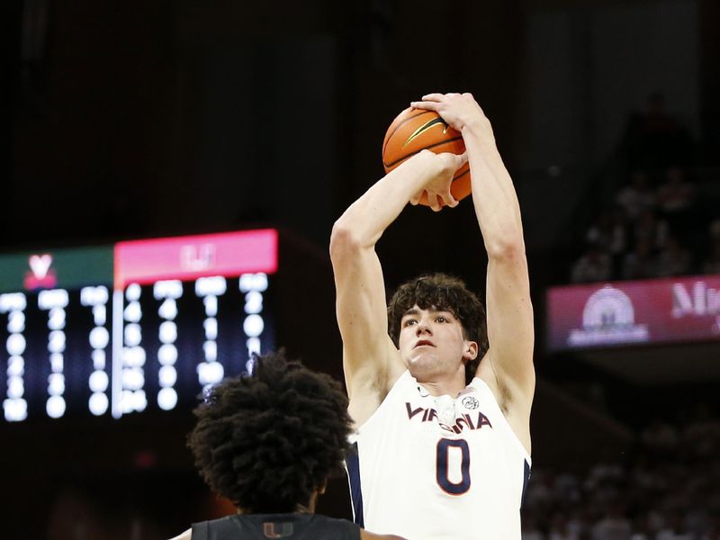 Feb 5, 2024; Charlottesville, Virginia, USA; Virginia Cavaliers forward Blake Buchanan (0) shoots the ball over Miami (Fl) Hurricanes forward Norchad Omier (15) during the second half at John Paul Jones Arena. Mandatory Credit: Amber Searls-USA TODAY Sports