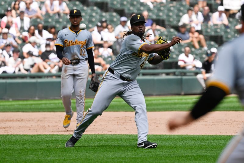 Jul 13, 2024; Chicago, Illinois, USA;  Pittsburgh Pirates pitcher Luis L. Ortiz (48) tries to throw out Chicago White Sox outfielder Luis Robert Jr. (88) at first base during the fourth inning at Guaranteed Rate Field. Mandatory Credit: Matt Marton-USA TODAY Sports