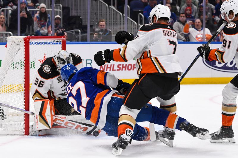 Dec 13, 2023; Elmont, New York, USA; Anaheim Ducks goaltender John Gibson (36) makes a save on New York Islanders left wing Anders Lee (27) during the second period at UBS Arena. Mandatory Credit: Dennis Schneidler-USA TODAY Sports