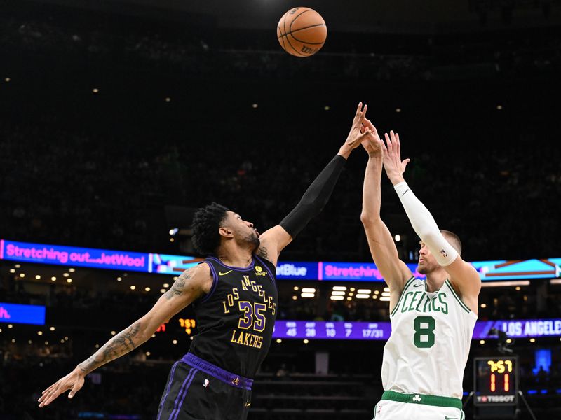 BOSTON, MASSACHUSETTS - FEBRUARY 01: Kristaps Porzingis #8 of the Boston Celtics attempts a shot past Christian Wood #35 of the Los Angeles Lakers during the fourth quarter at the TD Garden on February 01, 2024 in Boston, Massachusetts. NOTE TO USER: User expressly acknowledges and agrees that, by downloading and or using this photograph, User is consenting to the terms and conditions of the Getty Images License Agreement. (Photo by Brian Fluharty/Getty Images)