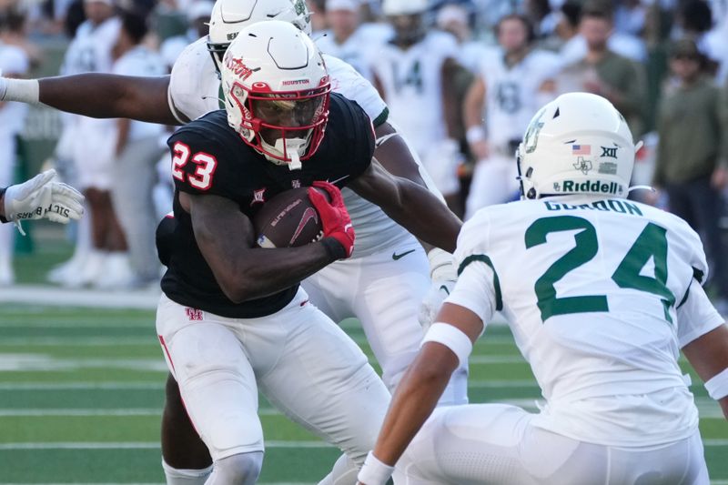 Nov 4, 2023; Waco, Texas, USA;  Houston Cougars running back Parker Jenkins (23) runs the ball against Baylor Bears safety Corey Gordon Jr. (24) during the second half at McLane Stadium. Mandatory Credit: Chris Jones-USA TODAY Sports