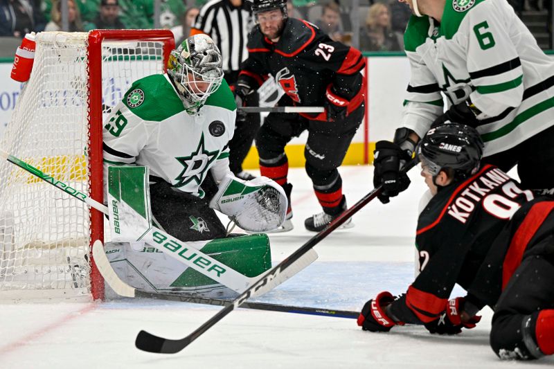 Jan 25, 2023; Dallas, Texas, USA; Dallas Stars goaltender Jake Oettinger (29) stops a shot by Carolina Hurricanes center Jesperi Kotkaniemi (82) during the first period at the American Airlines Center. Mandatory Credit: Jerome Miron-USA TODAY Sports