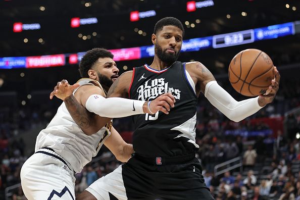 LOS ANGELES, CALIFORNIA - DECEMBER 06: Paul George #13 of the LA Clippers controls the ball against Jamal Murray #27 of the Denver Nuggets during the second half a game at Crypto.com Arena on December 06, 2023 in Los Angeles, California. NOTE TO USER: User expressly acknowledges and agrees that, by downloading and or using this photograph, User is consenting to the terms and conditions of the Getty Images License Agreement.  (Photo by Michael Owens/Getty Images)