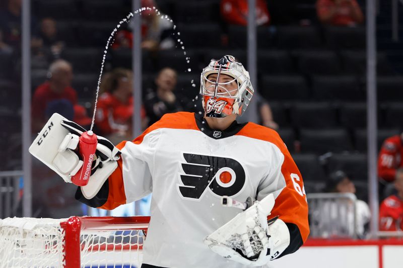 Sep 22, 2024; Washington, District of Columbia, USA; Philadelphia Flyers goaltender Carson Bjarnason (64) watches water squirted from his bottle during a timeout against the Washington Capitals in the third period at Capital One Arena. Mandatory Credit: Geoff Burke-Imagn Images