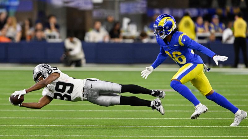 Las Vegas Raiders wide receiver Tre Tucker, left, makes a catch next to Los Angeles Rams cornerback Vincent Gray during the second half of a preseason NFL football game Saturday, Aug. 19, 2023, in Inglewood, Calif. (AP Photo/Alex Gallardo)