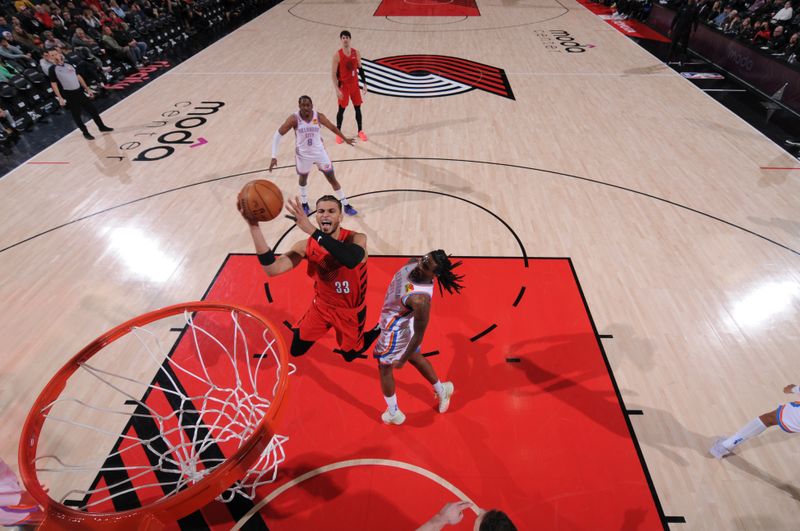 PORTLAND, OR - JANUARY 26: Toumani Camara #33 of the Portland Trail Blazers drives to the basket during the game against the Oklahoma City Thunder on January 26, 2025 at the Moda Center Arena in Portland, Oregon. NOTE TO USER: User expressly acknowledges and agrees that, by downloading and or using this photograph, user is consenting to the terms and conditions of the Getty Images License Agreement. Mandatory Copyright Notice: Copyright 2025 NBAE (Photo by Cameron Browne/NBAE via Getty Images)