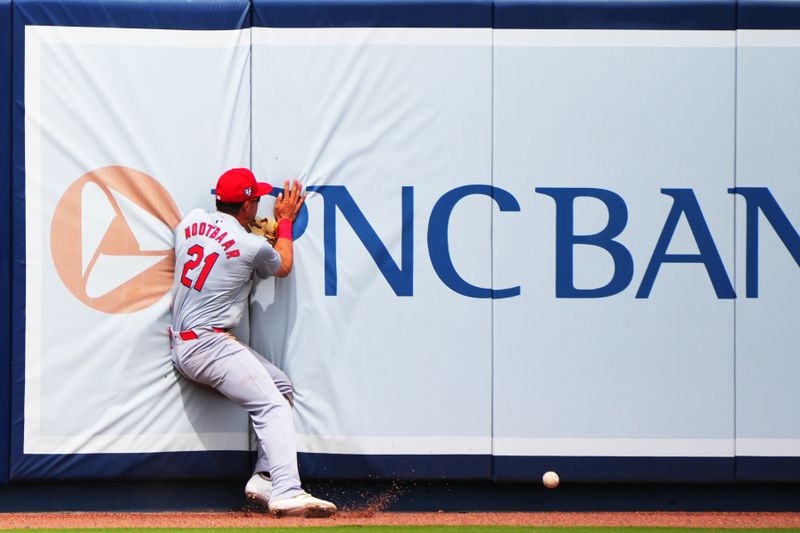 Mar 2, 2024; West Palm Beach, Florida, USA; St. Louis Cardinals center fielder Lars Nootbaar (21) runs into the wall while trying to catch a fly ball hit by Houston Astros second baseman Jose Altuve (27) in the third inning at The Ballpark of the Palm Beaches. Mandatory Credit: Jim Rassol-USA TODAY Sports