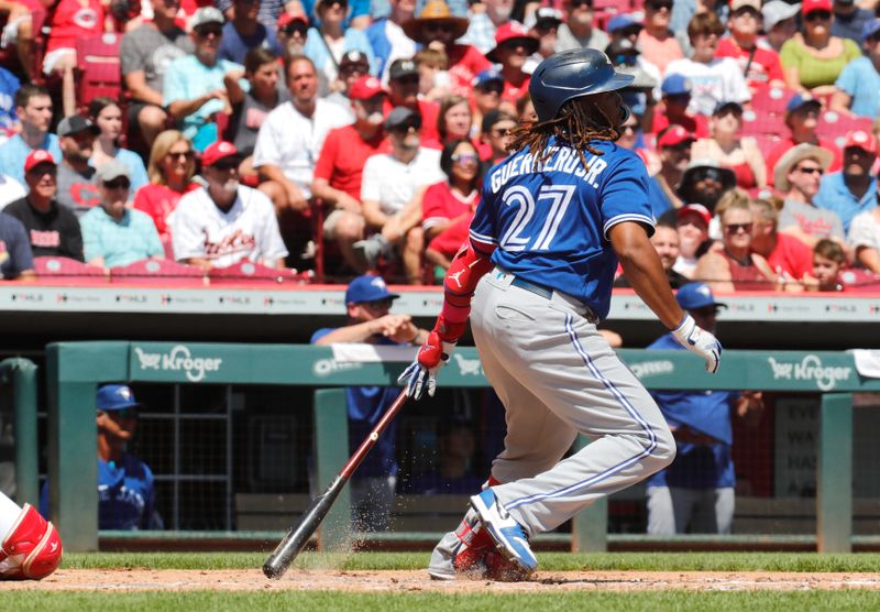 Aug 20, 2023; Cincinnati, Ohio, USA; Toronto Blue Jays first baseman Vladimir Guerrero Jr. (27) hits a single against the Cincinnati Reds during the second inning at Great American Ball Park. Mandatory Credit: David Kohl-USA TODAY Sports