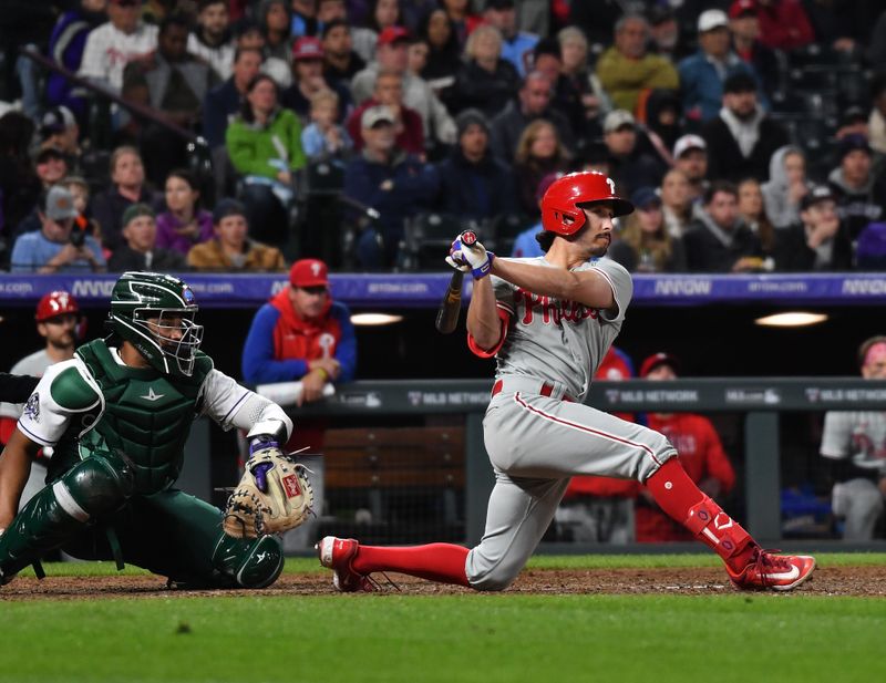 May 13, 2023; Denver, Colorado, USA; Philadelphia Phillies catcher Garrett Stubbs (21) hits double for an RBI in the eighth inning against the Colorado Rockies at Coors Field. Mandatory Credit: John Leyba-USA TODAY Sports