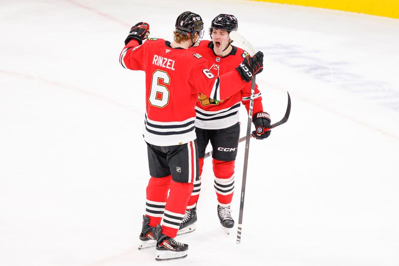 Oct 19, 2025; Chicago, Illinois, USA; Chicago Blackhawks center Ryan Donato (8) celebrates with defenseman Sam Rinzel (6) after scoring in overtime a game winning goal against the Anaheim Ducks at United Center. Mandatory Credit: Kamil Krzaczynski-Imagn Images