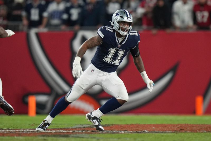 FILE - Dallas Cowboys linebacker Micah Parsons (11) follows a play during an NFL wild-card football game against the Tampa Bay Buccaneers, Monday, Jan. 16, 2023, in Tampa, Fla. Dallas star Micah Parsons sees himself and fellow All-Pro edge rusher and NFL sacks leader Nick Bosa of San Francisco as entertainers in their divisional playoff. Even though they won't be on the field together, the meeting Sunday night showcases two of the best young pass rushers in the league. (AP Photo/Peter Joneleit, File)