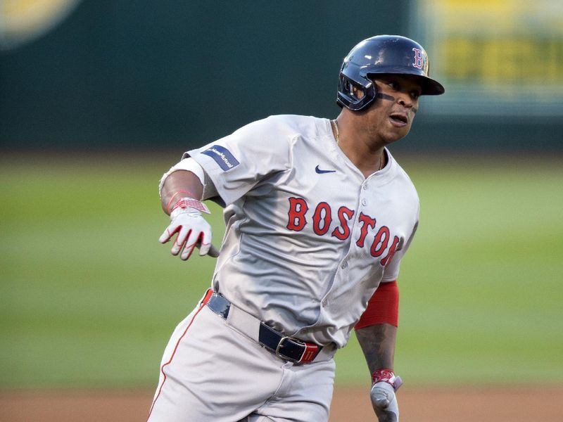 Apr 2, 2024; Oakland, California, USA; Boston Red Sox infielder Rafael Devers (11) rounds third and heads home on an RBI double by Trevor Story during the first inning against the Oakland Athletics at Oakland-Alameda County Coliseum. Mandatory Credit: D. Ross Cameron-USA TODAY Sports